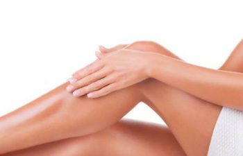 woman presents smooth legs after laser hair removal