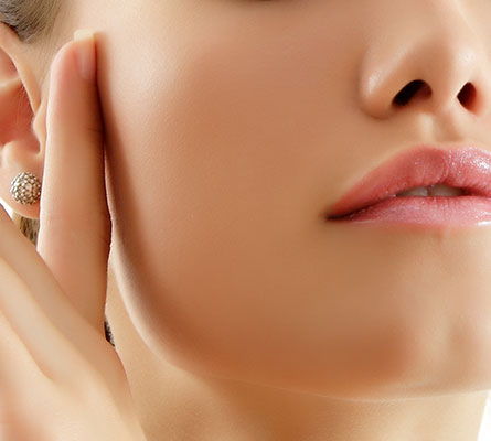 woman touching her face after Brown Spot Reduction Treatment