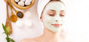 woman smiling during a facial treatment