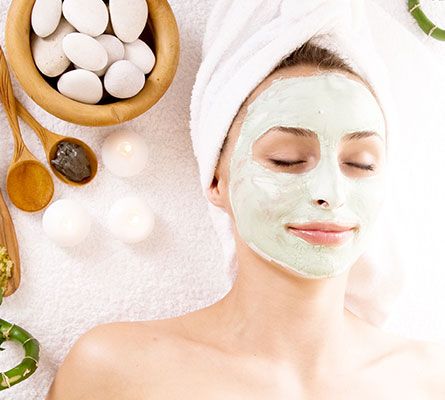 woman smiling during a facial treatment