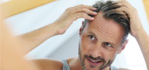 man checking his hair after a PRP Scalp Hair Growth Injection