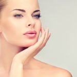 beautiful woman touching her face