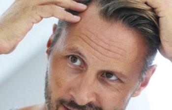 man checking his hair after a PRP Scalp Hair Growth Injection