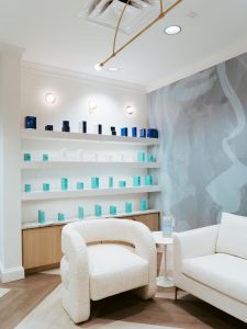 A waiting area with a display shelf with skincare products offered for sale at The K Spa in Atlanta GA.