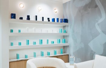 A waiting area with a display shelf with skincare products offered for sale at The K Spa in Atlanta GA.